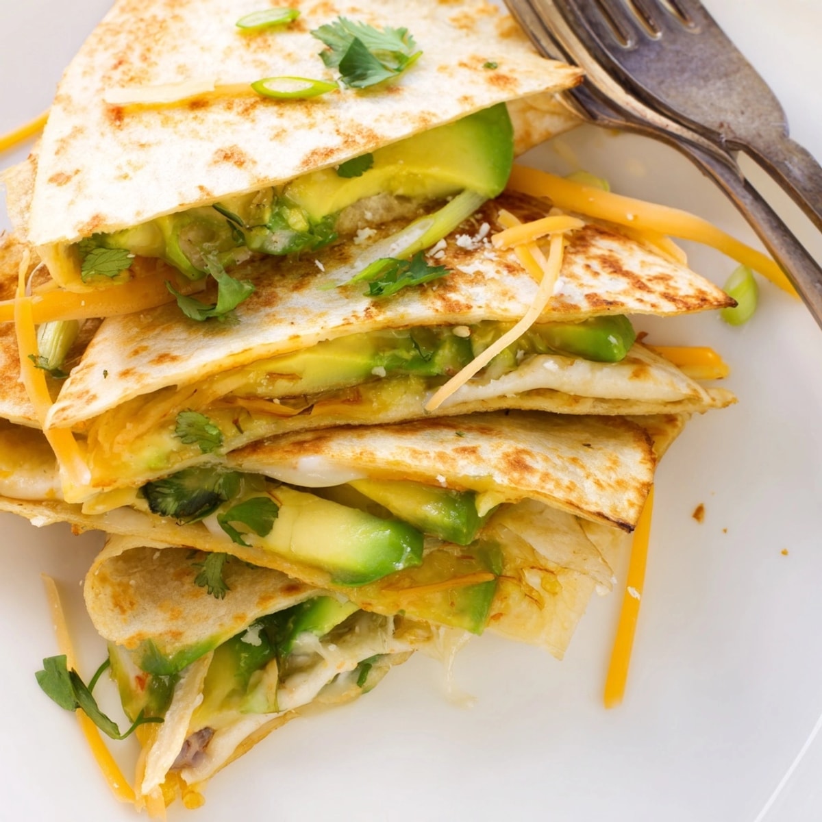 Golden Avocado Cheddar Grilled Quesadilla: melty cheese oozing, creamy avocado, sizzling in the pan.