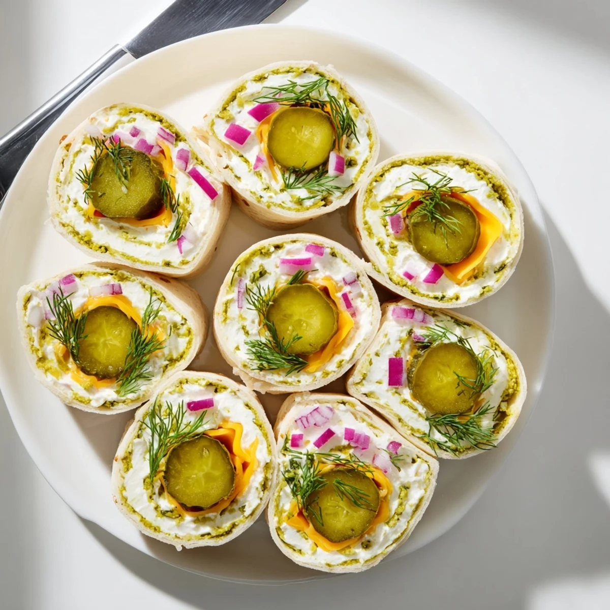 Delicious pickle-in-a-blanket snack, featuring pickles, cheese, and creamy tortillas.  