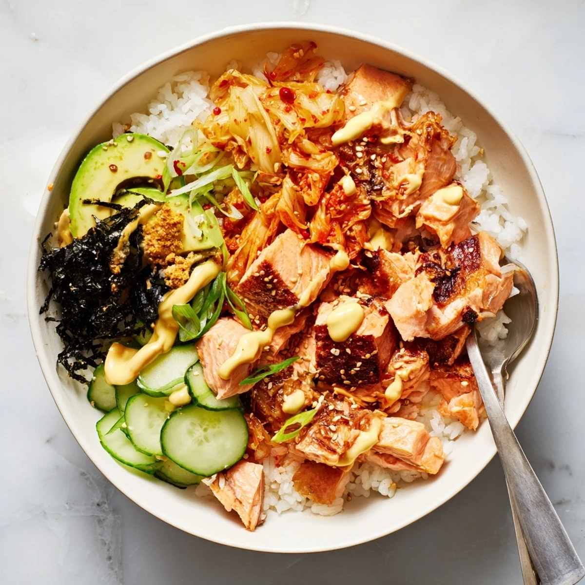 Flavorful crispy salmon served over golden rice with kimchi and crunchy garlic.  