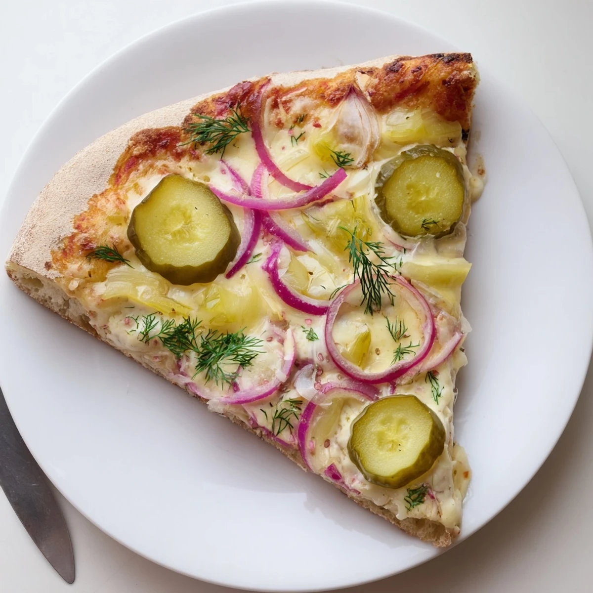Creamy Pickle Pizza topped with dill pickles and bubbling mozzarella cheese.  