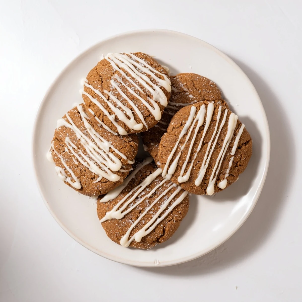 Warm, spiced gingerbread latte cookies drizzled with white chocolate offer sweet winter cheer.