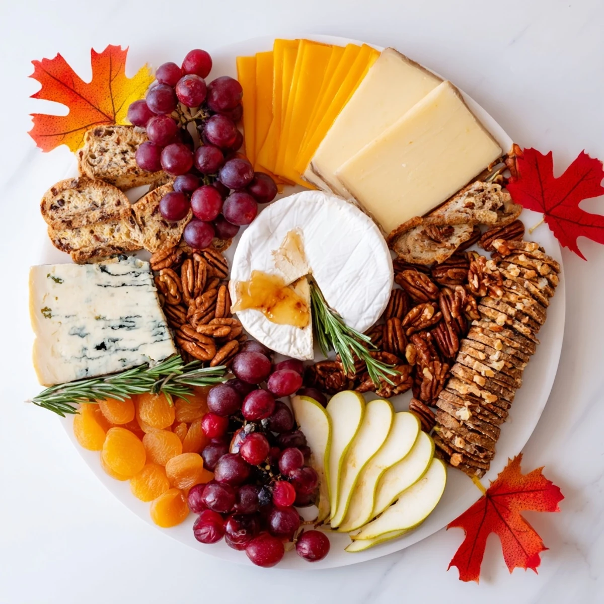 This appetizing Autumn Leaf Cheese Platter features a vibrant array of cheeses, crackers, and autumnal decorations.