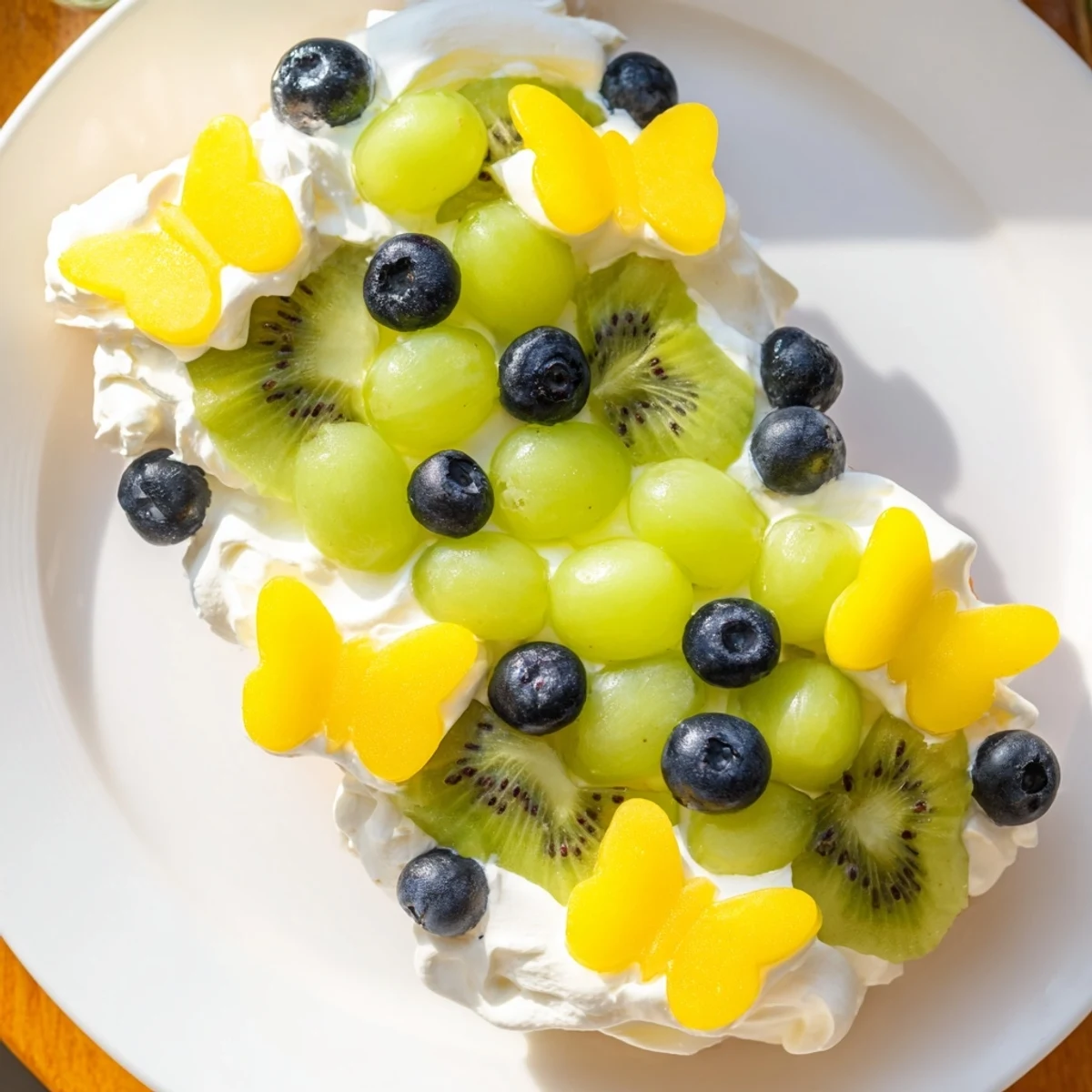 A beautiful Butterfly Fruit and Cream Cheese Board features colorful fruits arranged with creamy cheese, ready to eat.