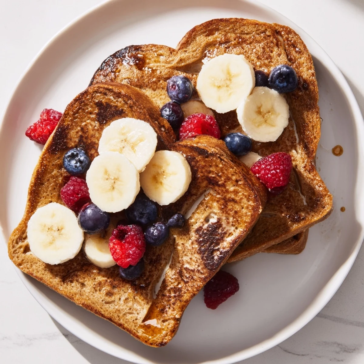 Golden-brown Protein French Toast, topped with fresh berries, promises a delicious, high-protein breakfast.