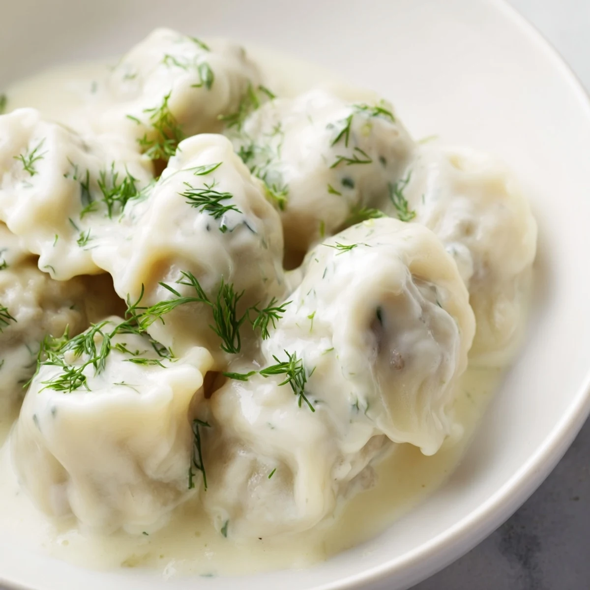 A close-up of golden, cooked Russian pelmeni, their savory filling ready to be enjoyed.