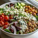 Hearty Mediterranean Farro Bowl with fluffy farro, spinach, olives, and roasted vegetables, ready for a healthy lunch.