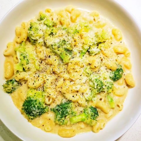 Steaming bowl of One-Pot Broccoli Cheddar Ditalini Soup; cheesy, golden, and ready for a cold evening.