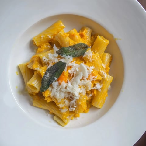 Golden roasted butternut squash and sage goat cheese pasta, ready to serve with crispy sage topping.