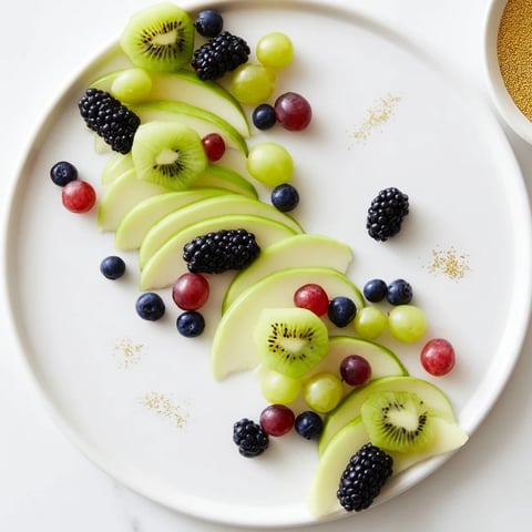 A colorful Aurora Borealis Sweep, a stunning fruit platter with green and purple fruits arranged beautifully.