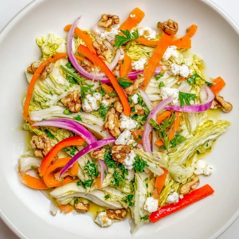 Warm sautéed Cooked and Loved Cabbage Salad with crisp carrots and bell peppers, tossed in a tangy herbaceous dressing.