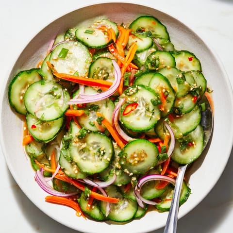 Vibrant cucumber salad remix featuring colorful veggies and a savory fish sauce dressing.  
