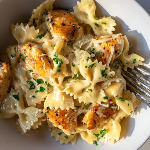Delicious pasta and tender chicken in a rich garlic butter sauce, perfect for dinner.  