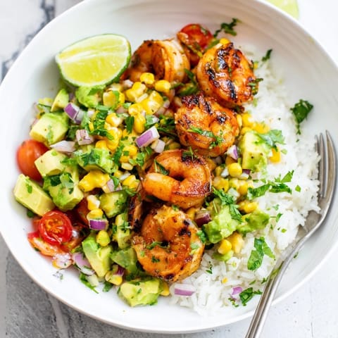 Savor the zesty flavors of Easy Grilled Shrimp Bowl with creamy avocado and corn.  