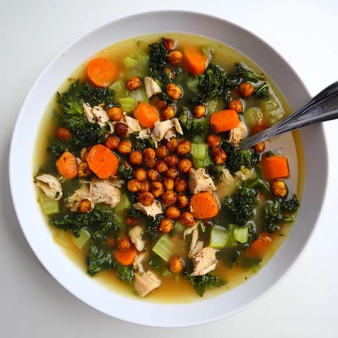 A steaming bowl of Chicken Kale Soup, promising a comforting, healthy meal, visually appealing with vibrant colors.
