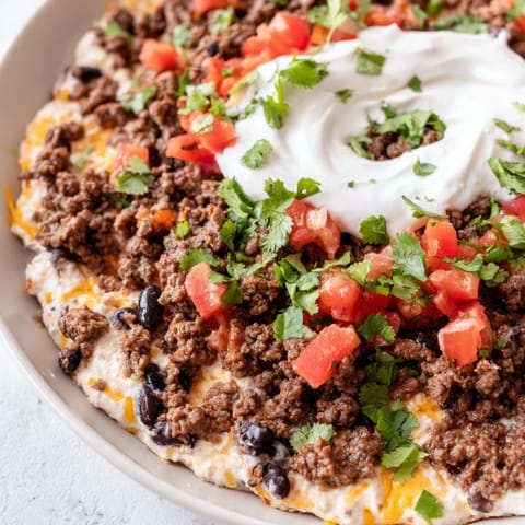 A hearty photo of Slow Cooker Cream Cheese Taco Dip, creamy and flavorful, ready to serve at a party.