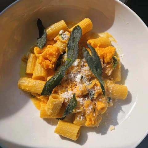 A close-up of creamy roasted butternut squash and sage goat cheese pasta, flavorful and comforting.