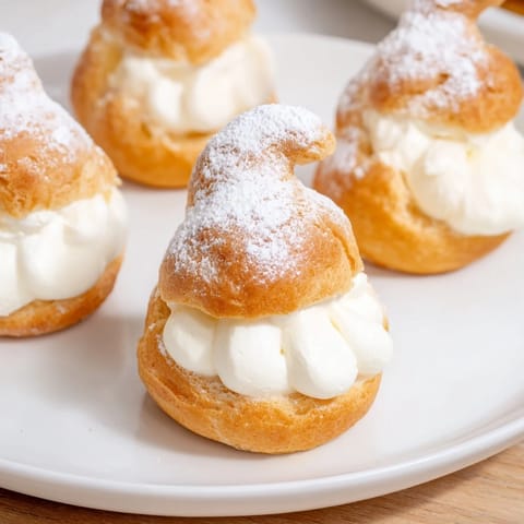 Freshly baked Elegant Swan Mini Pastries with a creamy vanilla filling, perfect for tea time.