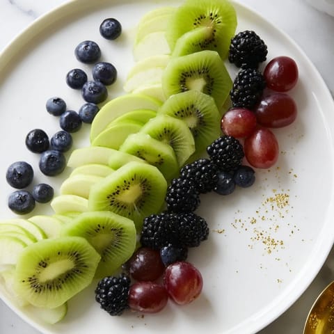 This Aurora Borealis Sweep features ripe, glistening fruits artfully placed, ready to serve as a dazzling snack.