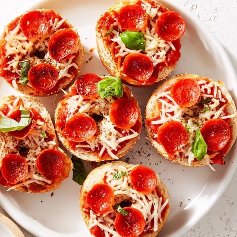 Bite-sized Mini Pepperoni Pizza Bagels fresh from the oven, featuring gooey cheese and savory pepperoni.
