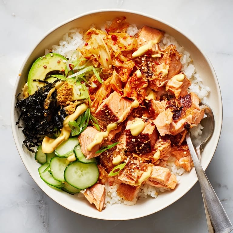 Flavorful crispy salmon served over golden rice with kimchi and crunchy garlic.  