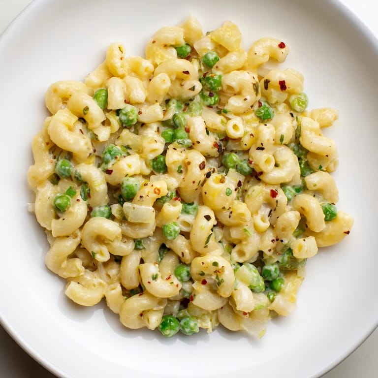 A close-up shot of hot, delicious Macaroni & Peas, perfect for a quick, family-friendly dinner.