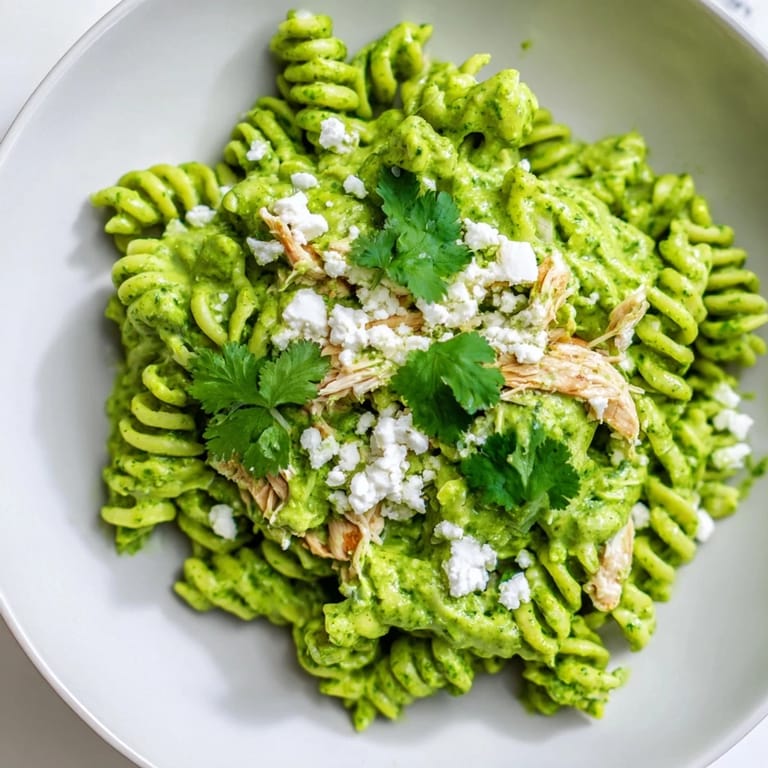 Cilantro Lime Chicken Pasta served warm with lime wedges and fresh cilantro garnish on a rustic plate.