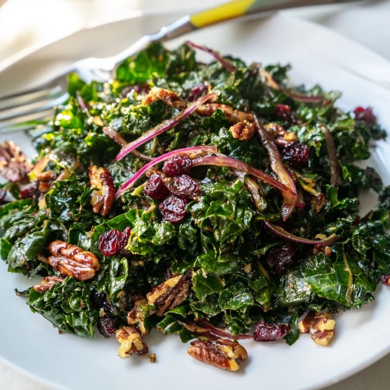 Hearty warm kale salad with maple mustard dressing, ready to serve.