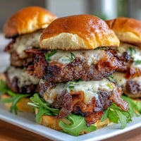 Juicy Father's Day grilled bacon burger sliders with melted cheese, perfect family feast.